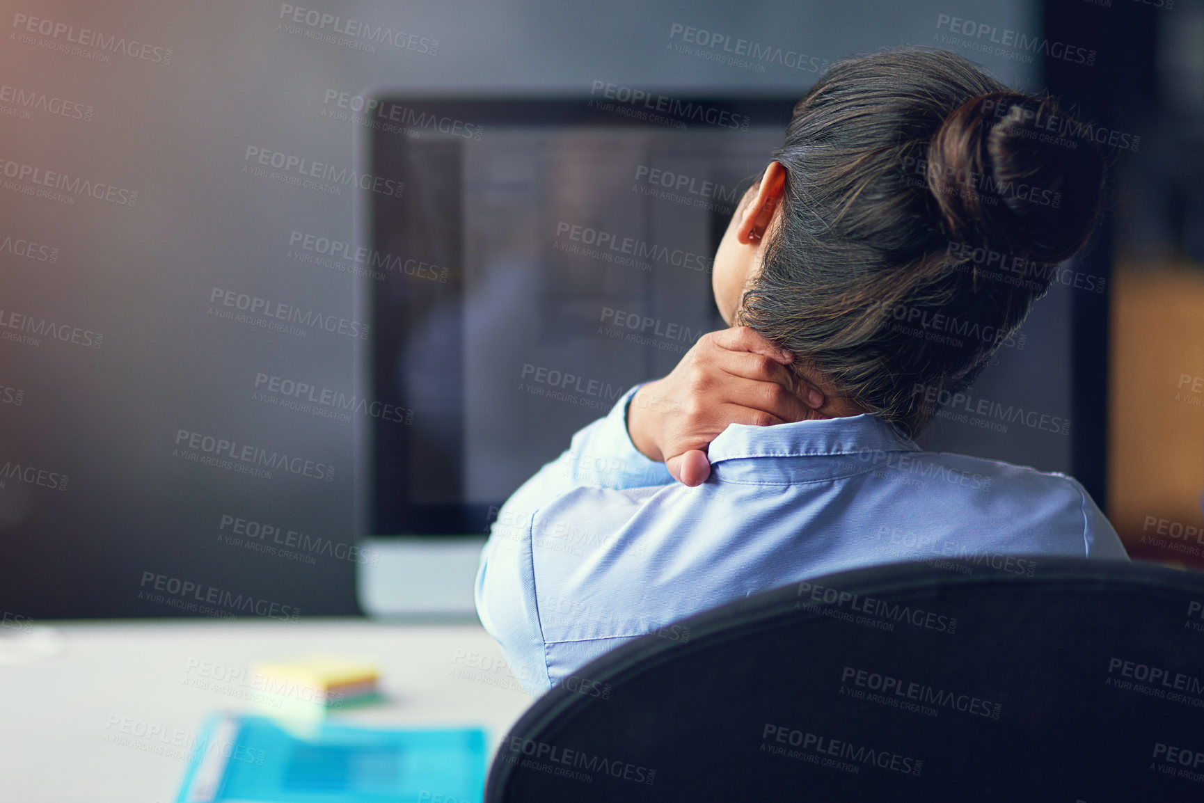 Buy stock photo Rearview shot of a businesswoman suffering from neck pain at the office