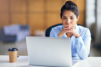 Buy stock photo Shot of a young businesswoman looking stressed while working at her desk