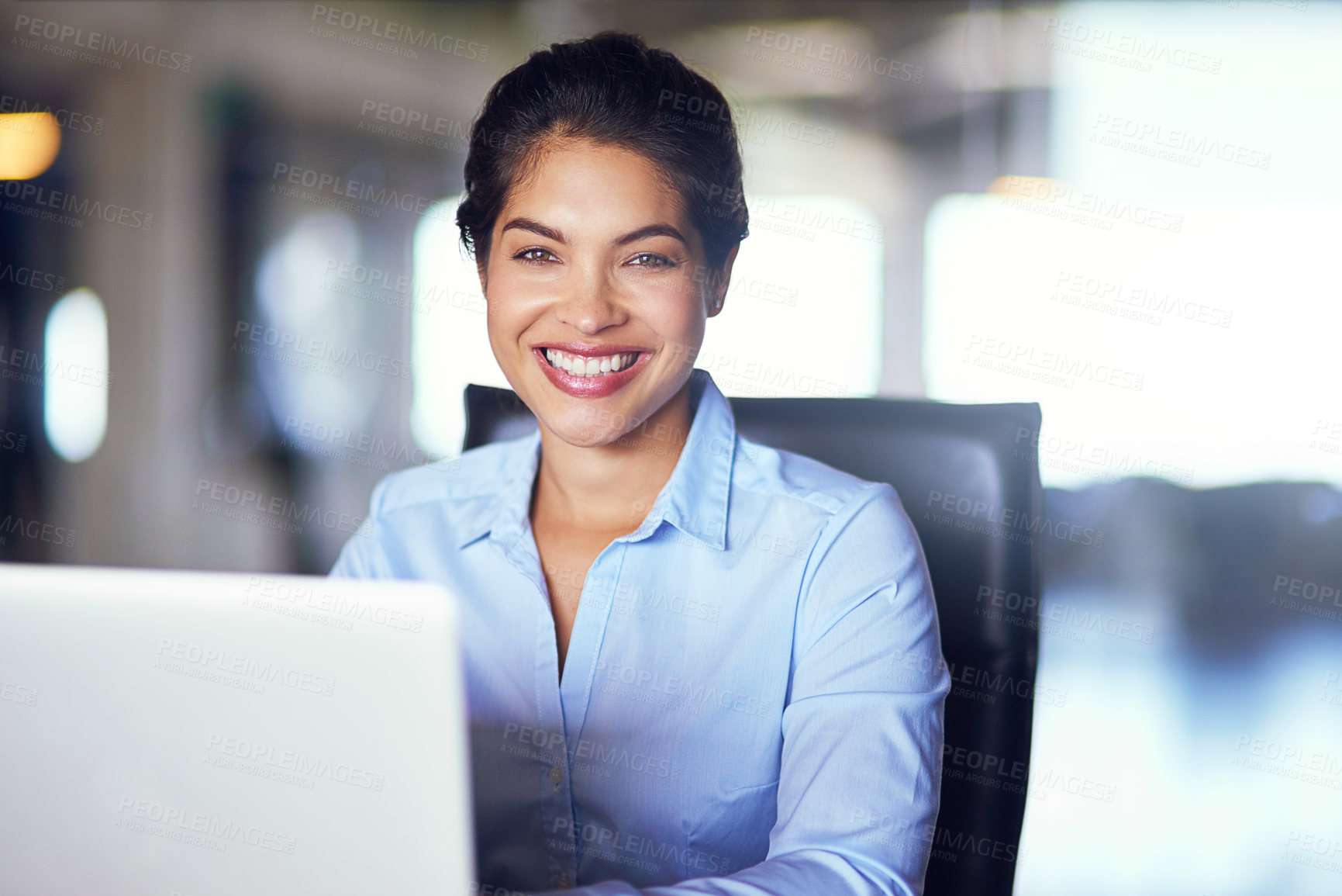 Buy stock photo Portrait of a young businesswoman working on her laptop in the office