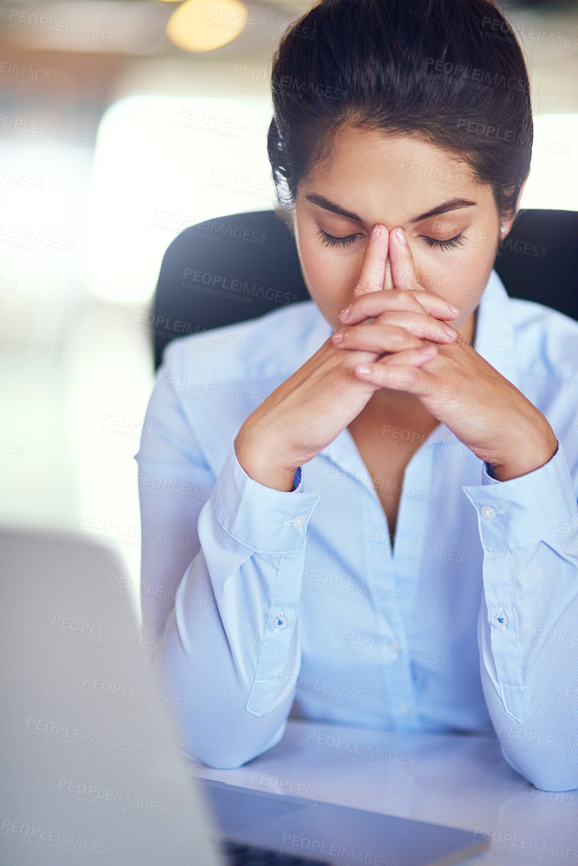 Buy stock photo Shot of a young businesswoman looking stressed while sitting at her desk
