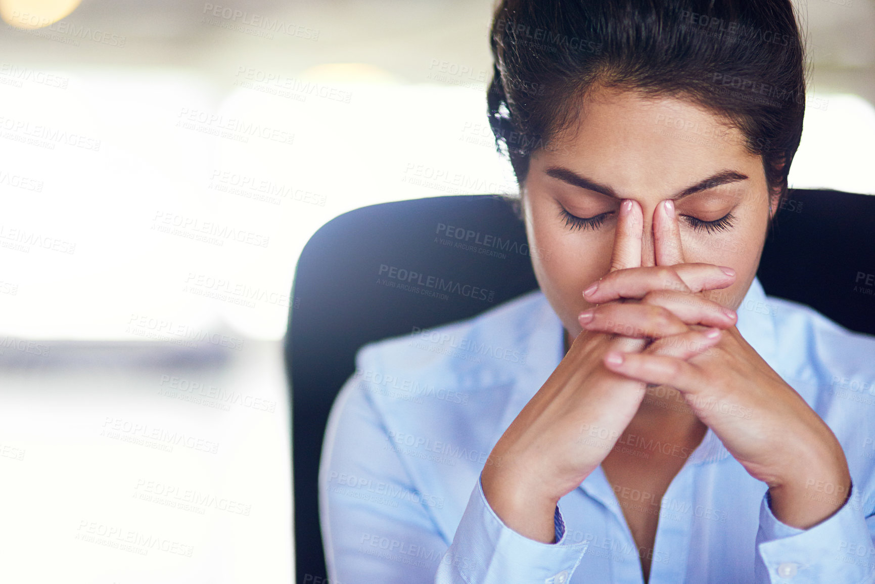 Buy stock photo Shot of a young businesswoman looking stressed while sitting in her office chair