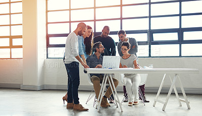 Buy stock photo Shot of a group of coworkers having a meeting in an open plan office