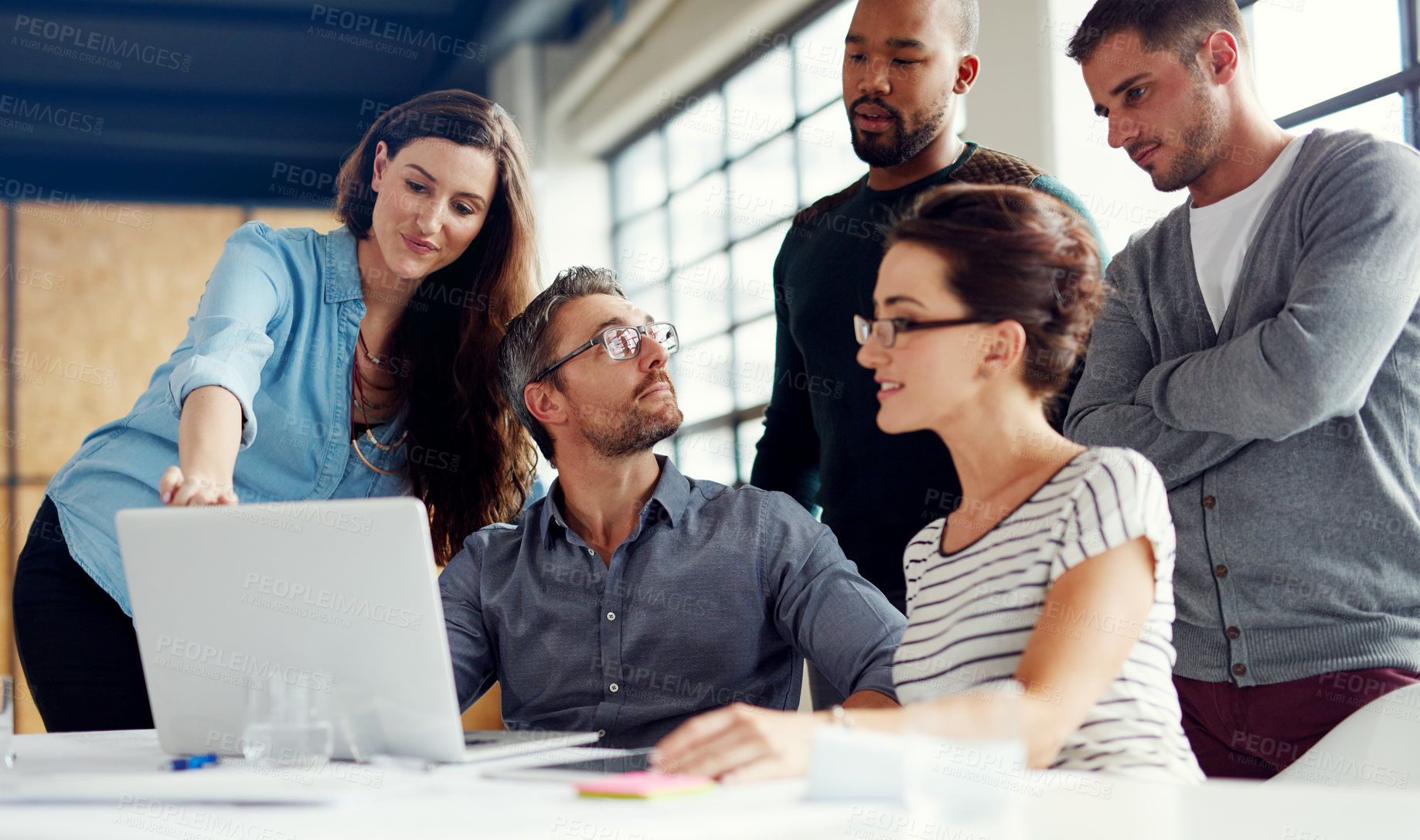 Buy stock photo Shot of a group of coworkers having a meeting in an open plan office