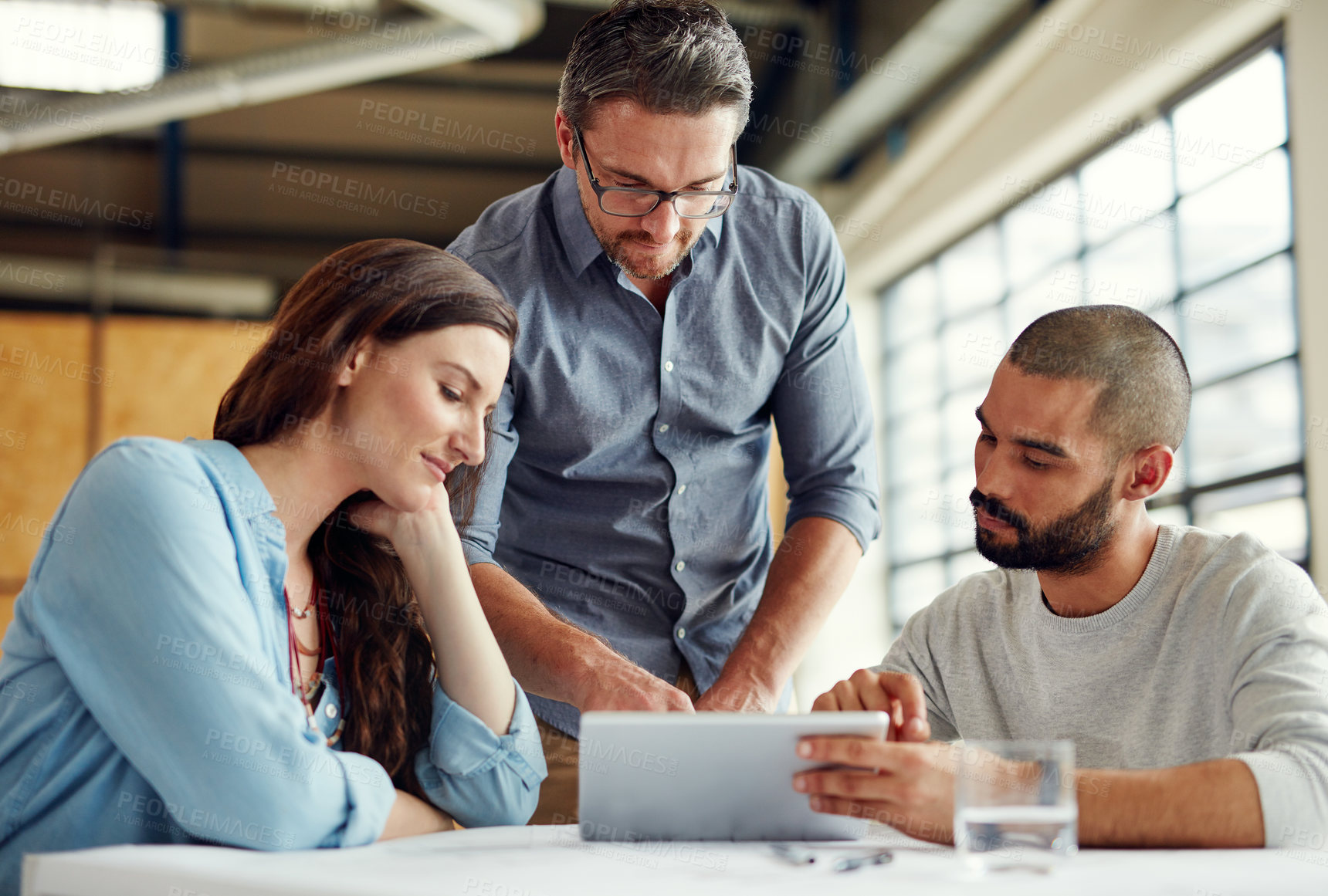 Buy stock photo Shot of a group of coworkers having a meeting in an open plan office