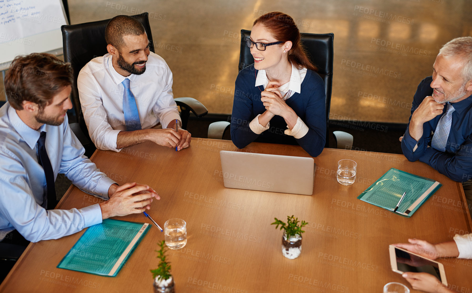 Buy stock photo Shot of a group of businesspeople having a boardroom meeting