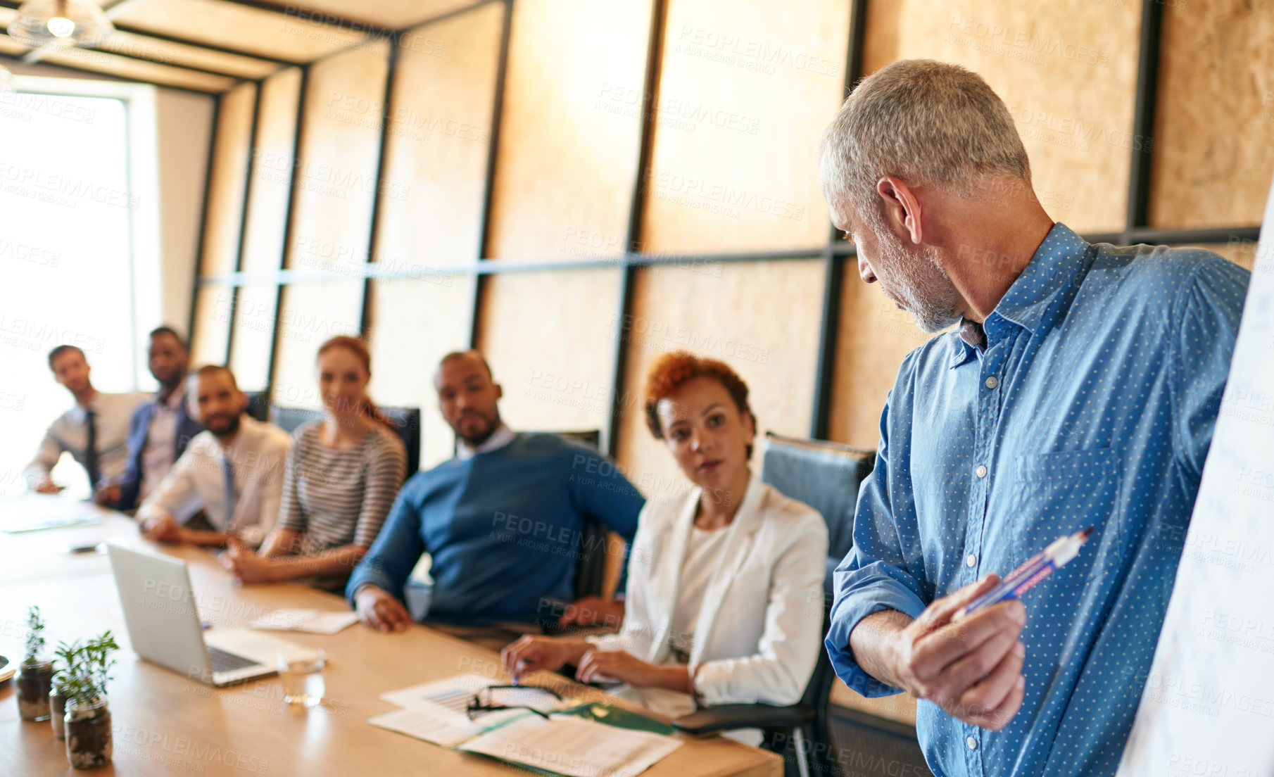 Buy stock photo Businessman, presentation and coaching team with whiteboard for brainstorming or collabration at office. Mature man, mentor or executive with group of employees for ideas, meeting or training staff