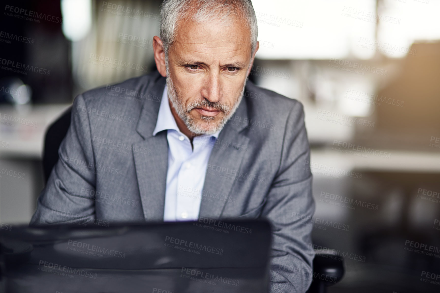 Buy stock photo Cropped shot of a mature businessman working in his office