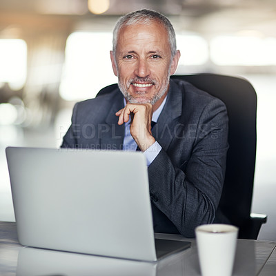 Buy stock photo Cropped portrait of a mature businessman working in his office