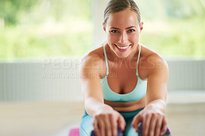 Buy stock photo Shot of an attractive young woman doing yoga at home