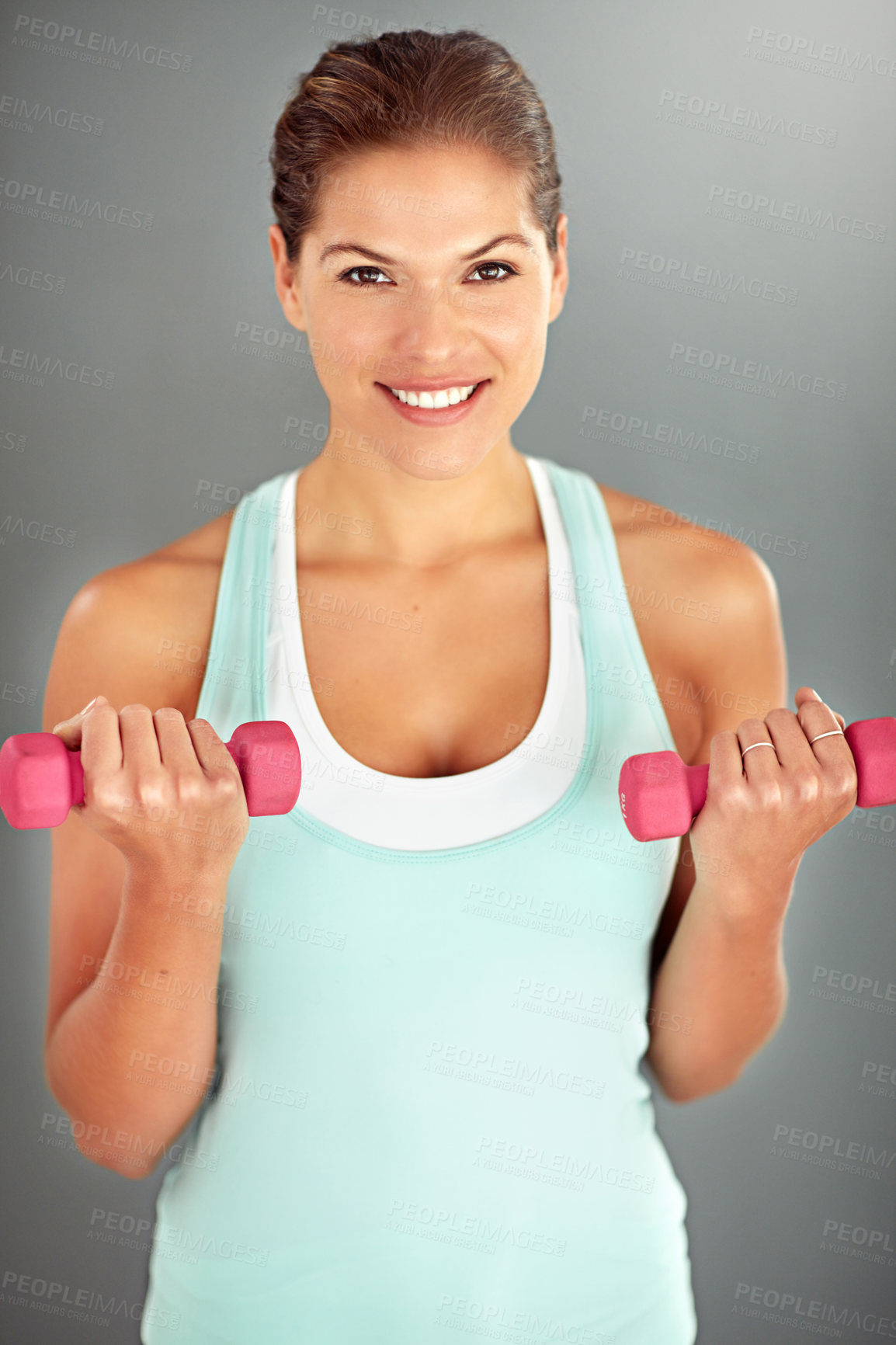 Buy stock photo Portrait, dumbbells and woman with fitness, energy and exercise on grey studio background. Face, healthy person and athlete with equipment, workout and smile with wellness, lose weight and challenge