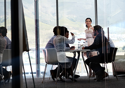Buy stock photo Shot of a businesswoman giving a presentation to a group of colleagues in a boardroom
