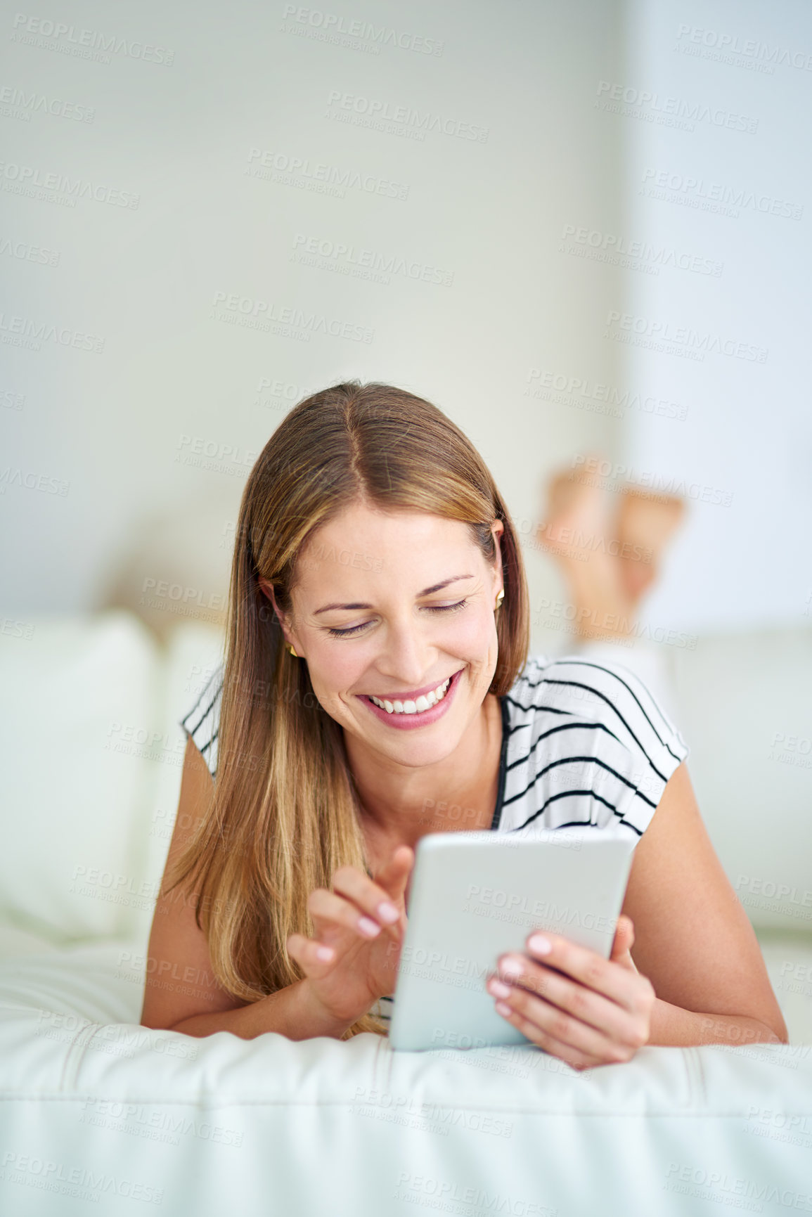 Buy stock photo Woman, tablet and laugh for funny message in bedroom, reading comedy fiction and dating website. Female person, home and app for streaming movies or comic film, surfing social media and online games