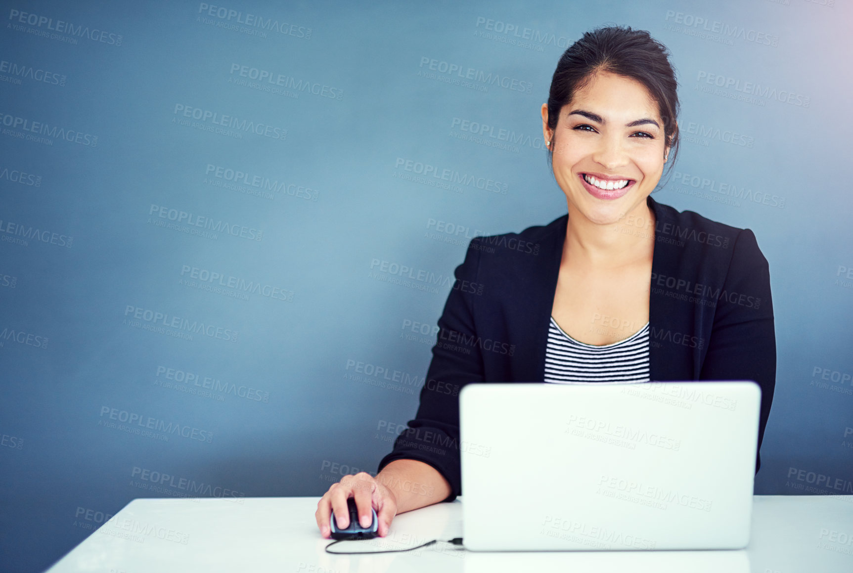 Buy stock photo Shot of a young businesswoman working at her desk