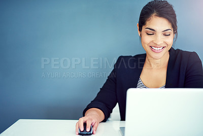 Buy stock photo Shot of a young businesswoman working at her desk