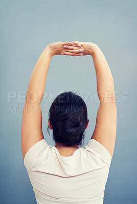 Buy stock photo Woman, work and stretching arms on studio, blue background or tired body from working, bad posture or strain. Stretch, arm and hands or businesswoman focus on care of back pain and stress management