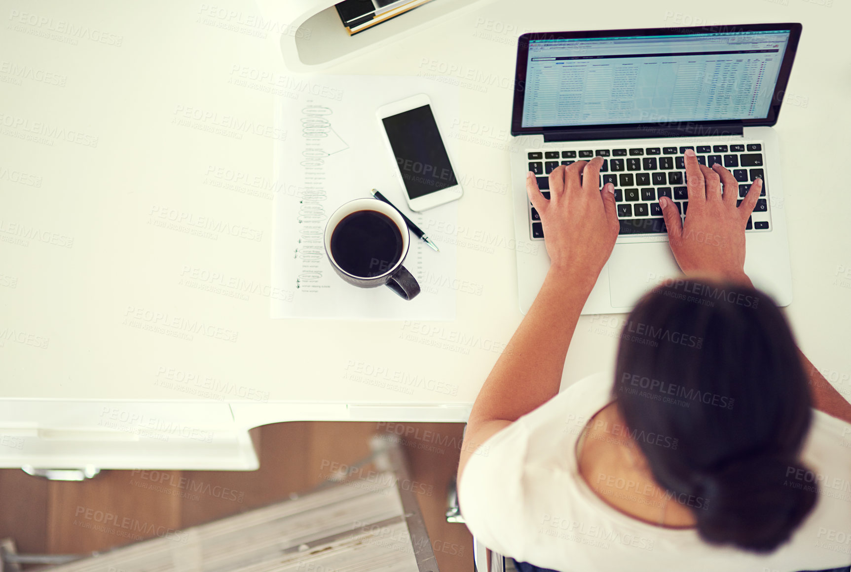 Buy stock photo High angle shot of a young businesswoman working on her laptop at home