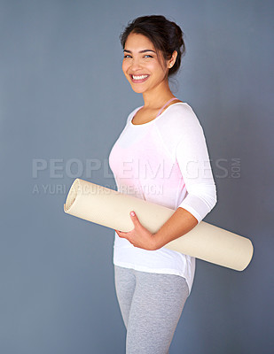 Buy stock photo Portrait, yoga mat and happy woman in studio for exercise, fitness and healthy body. Pilates, smile and girl with equipment for wellness and holistic practice isolated on grey background in Mexico