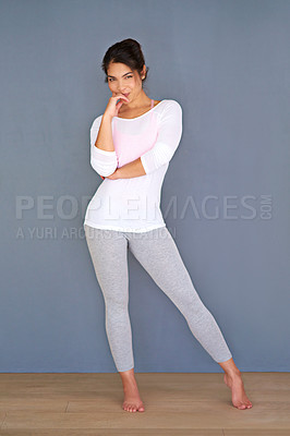 Buy stock photo Full length shot of a sporty young woman standing against a grey background