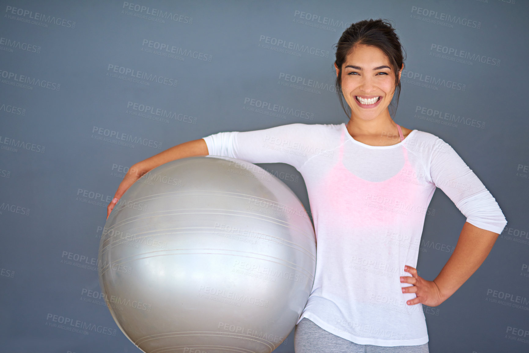 Buy stock photo Fitness, happy woman and exercise ball in yoga portrait for core workout, balance and weight loss in studio. Yogi, smile and wellbeing equipment for health, wellness and pilates on grey background