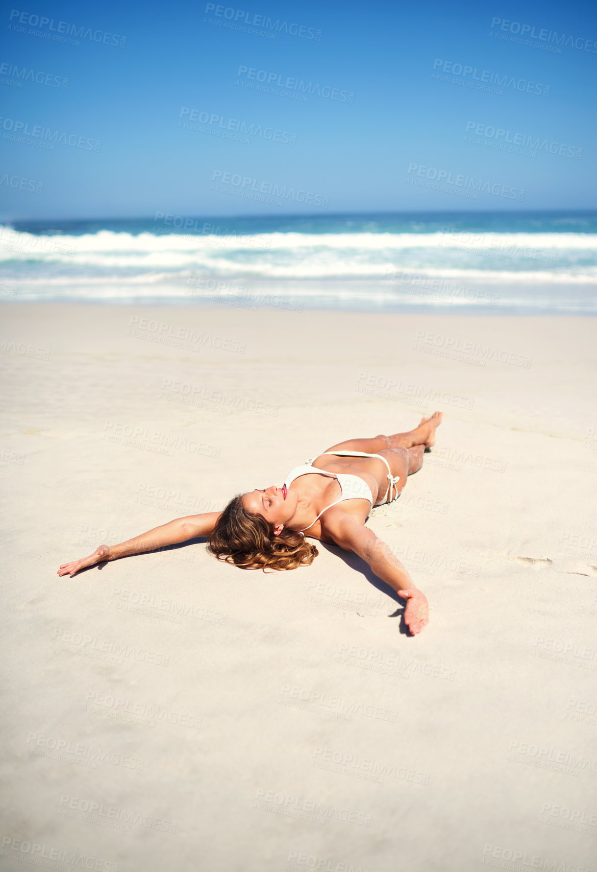 Buy stock photo Freedom, lying and girl on beach for sunbathing, tanning and outdoor on seaside with calm. Ocean, sand and female person in California for vacation, weekend holiday and adventure for summer break