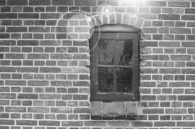 Buy stock photo Brick wall, black and white or window of house, home or city building with pattern, light or texture. Monochrome style, architecture exterior or traditional construction design on firm old structure