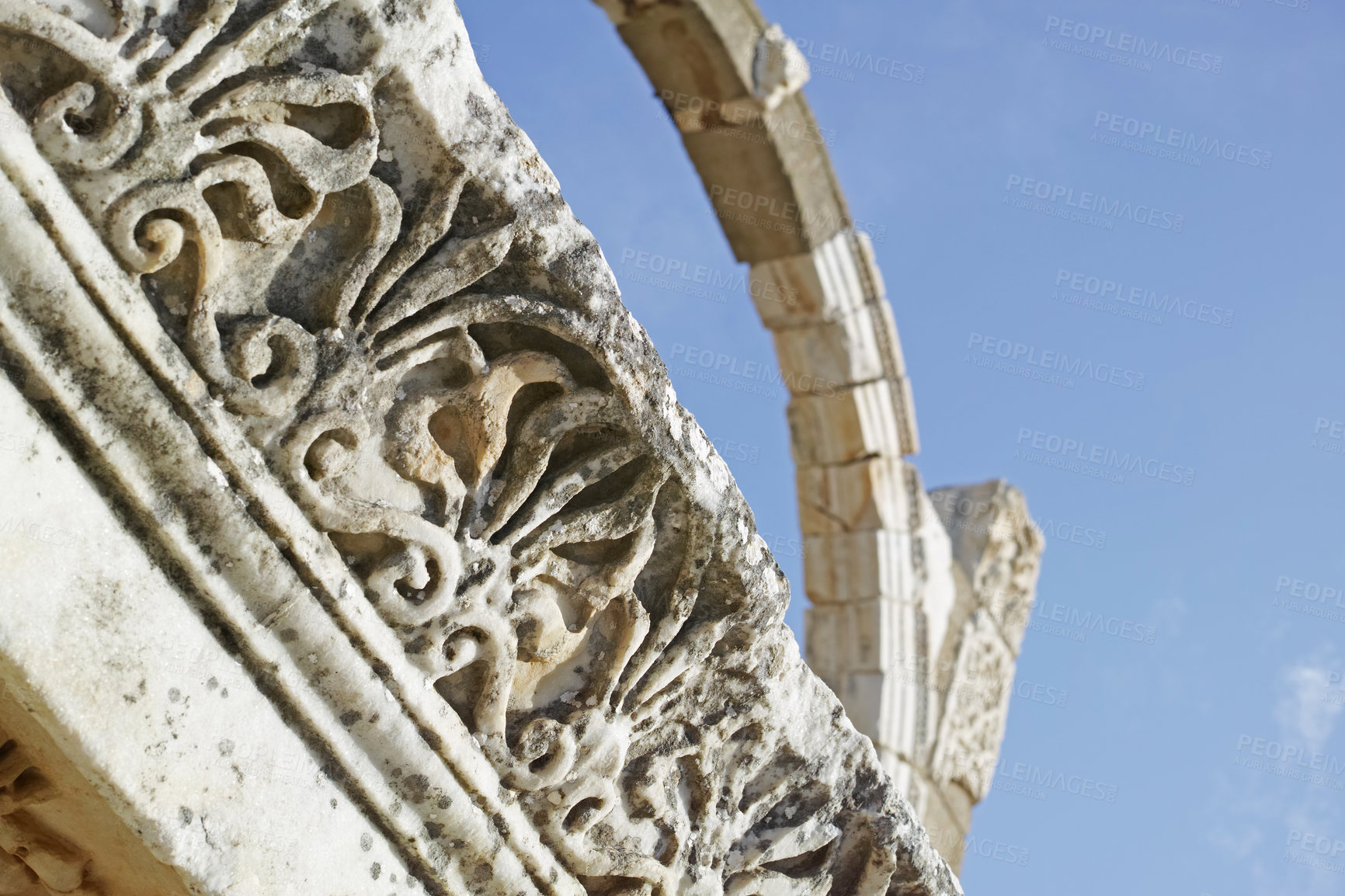 Buy stock photo Below view of ancient city ruins in a historical village. Traveling abroad and overseas for holiday, vacation, tourism. Low angle view of stone arch remains of old cultural buildings with history