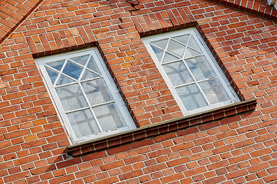 Buy stock photo Old stone wall with two rectangular windows. Close up of rectangular windows of a building with a red brick wall. Patterned windows on a red stained brick wall of an old building or house