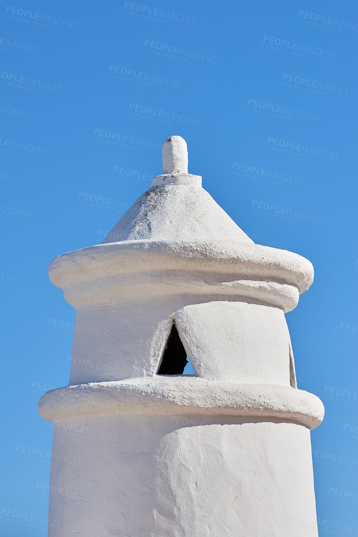 Buy stock photo White chimney or bell tower designed on the roof of a house or building against a clear blue sky background with copyspace. Construction of exterior architectural structure at a historical monument