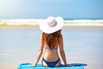 Buy stock photo Rearview shot of a young woman taking a selfie at the beach