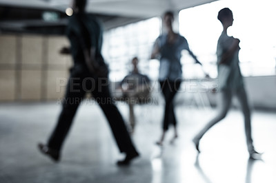 Buy stock photo Full length shot of a group of businesspeople walking through an office