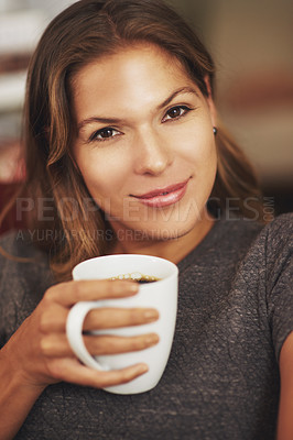 Buy stock photo Portrait of a young woman enjoying a cup of coffee at home