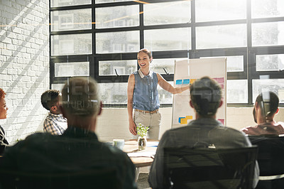 Buy stock photo Shot of a businessman giving a presentation to his colleagues