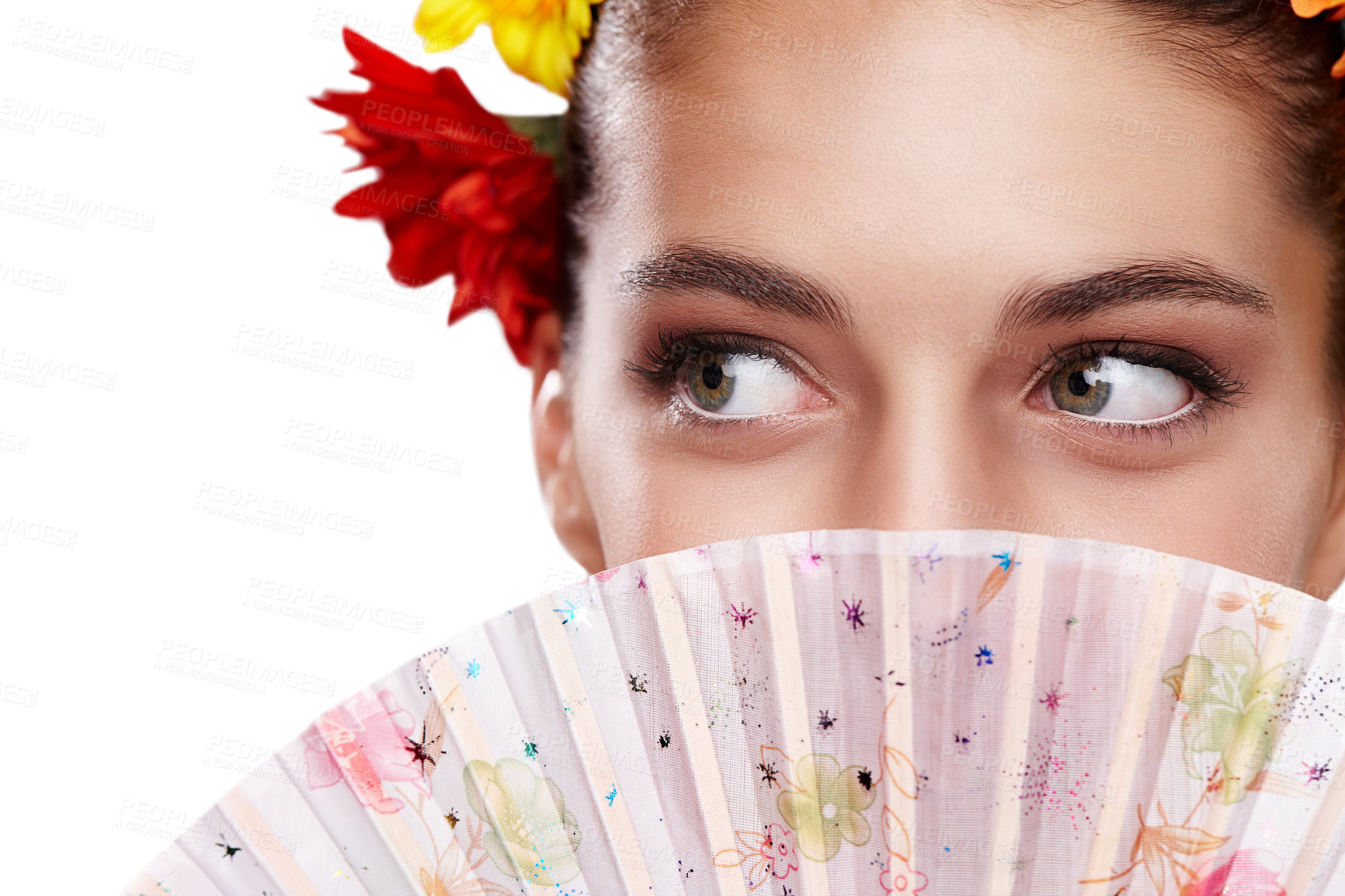 Buy stock photo Cropped shot of a beautiful young woman wearing a crown of flowers while holding a fan in front of her face