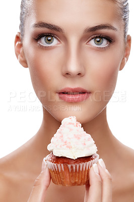 Buy stock photo Studio portrait of a beautiful woman holding up a cupcake