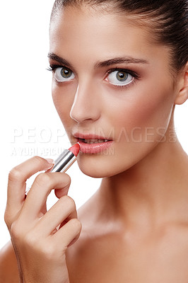 Buy stock photo Studio shot of a beautiful young woman applying lipstick isolated on white