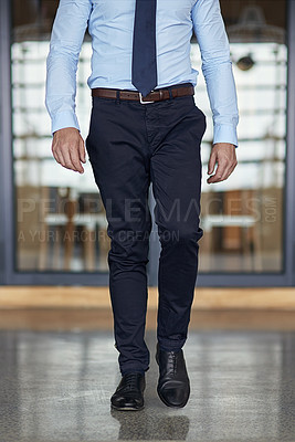 Buy stock photo Cropped shot of a businessman walking through his office