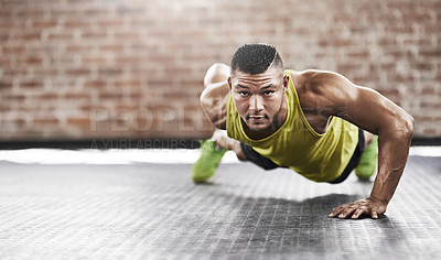 Buy stock photo Full length shot of a young man working out in the gym