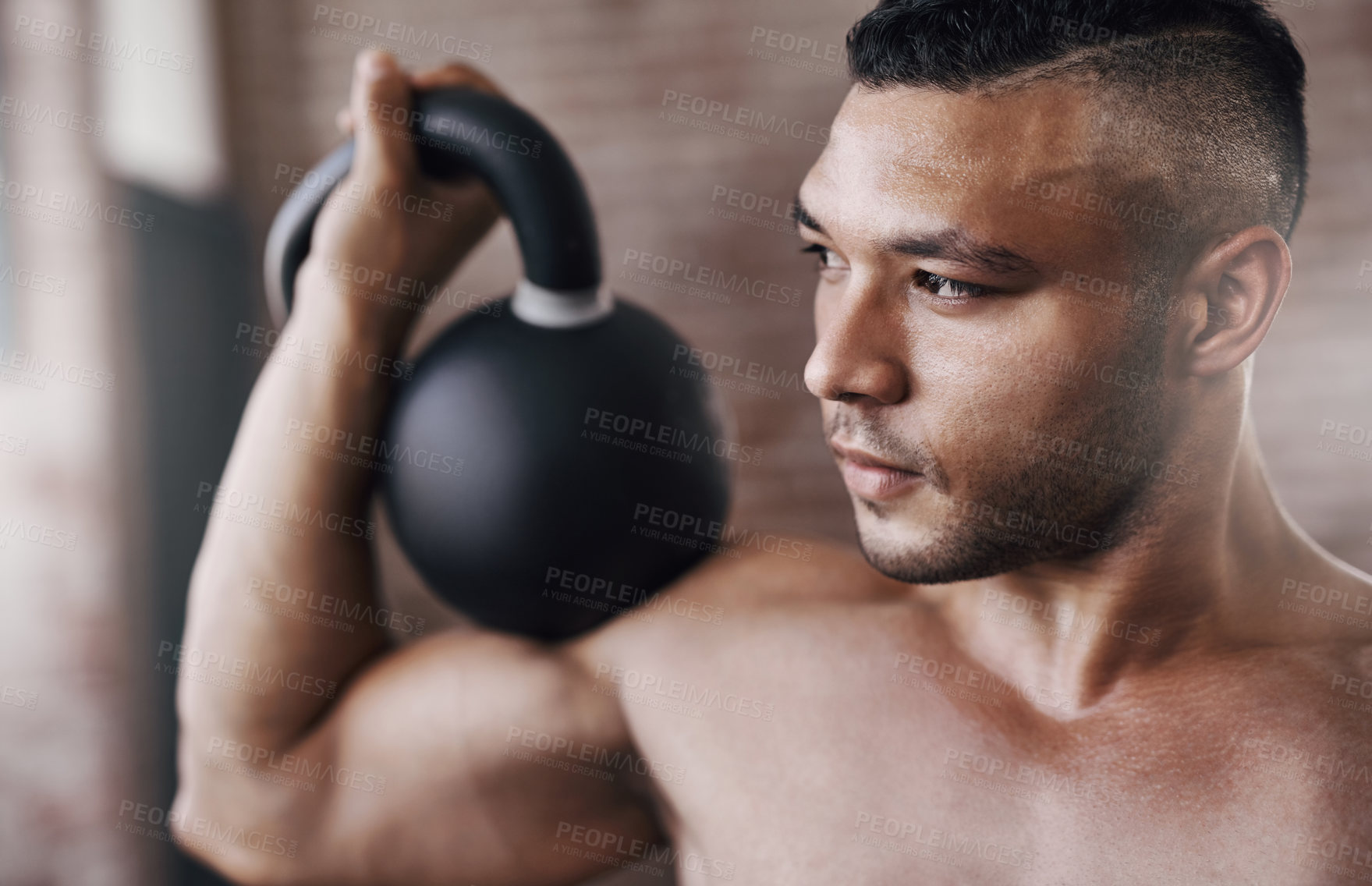 Buy stock photo Fitness, strong and man with kettlebell in gym for muscle development, weightlifting or endurance challenge. Energy, shirtless and athlete for bodybuilding, workout routine or performance exercise