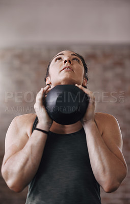 Buy stock photo Cropped shot of a young woman working out in the gym