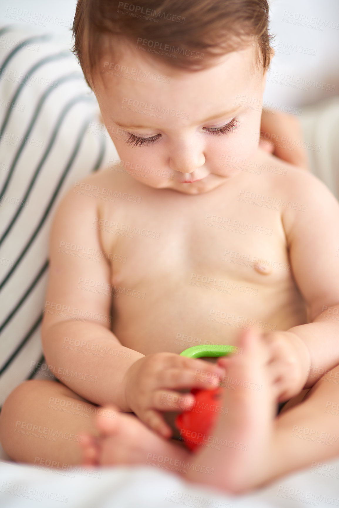 Buy stock photo Cropped shot of an adorable baby girl playing with a toy