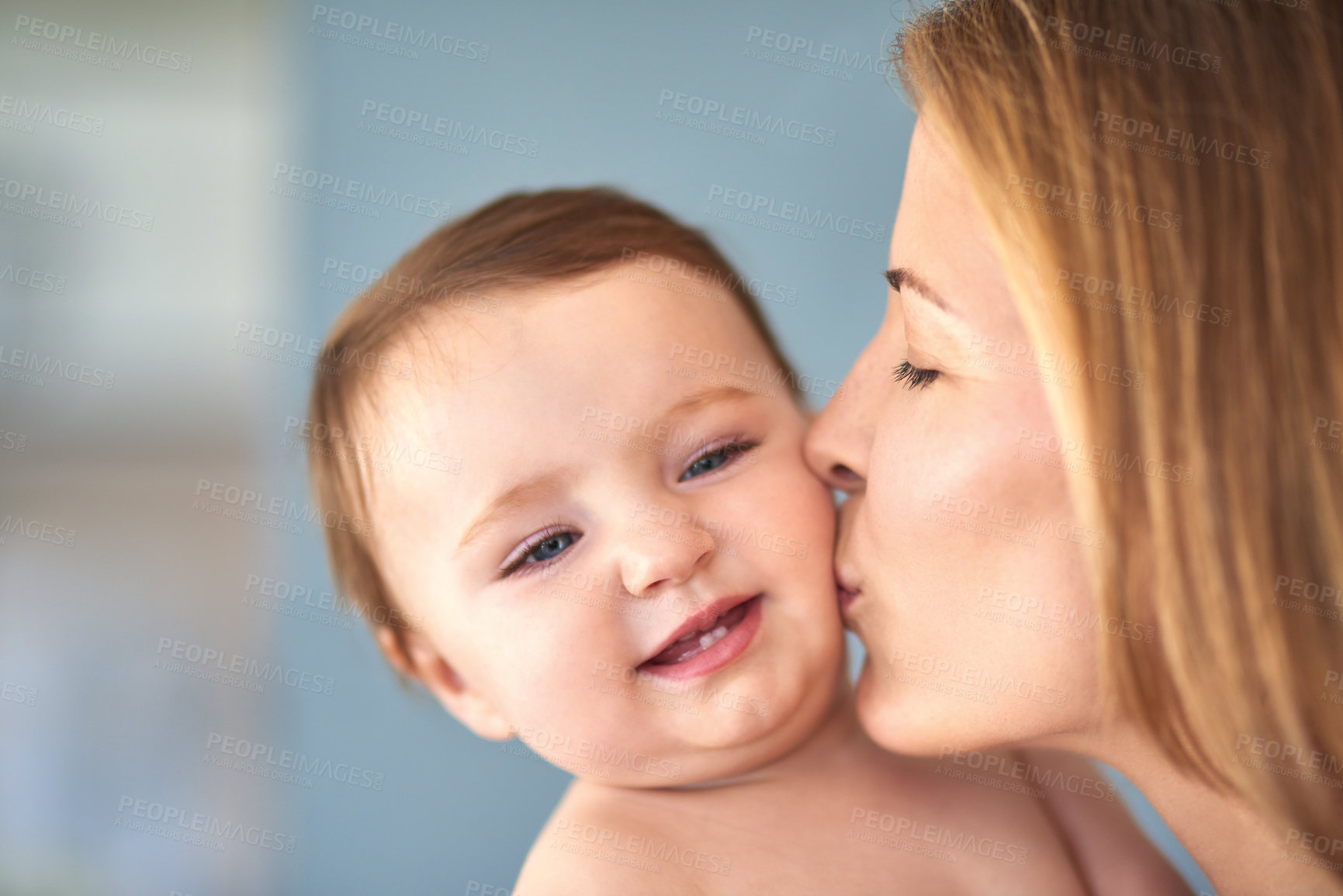 Buy stock photo Mom, baby and happy with kiss for care or childcare with support, love and cute as toddler and child development. Parent, kid and smile at home for bonding, childhood memories and safety with trust