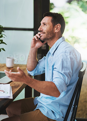 Buy stock photo Cropped shot of a businessman talking on his cellphone at home