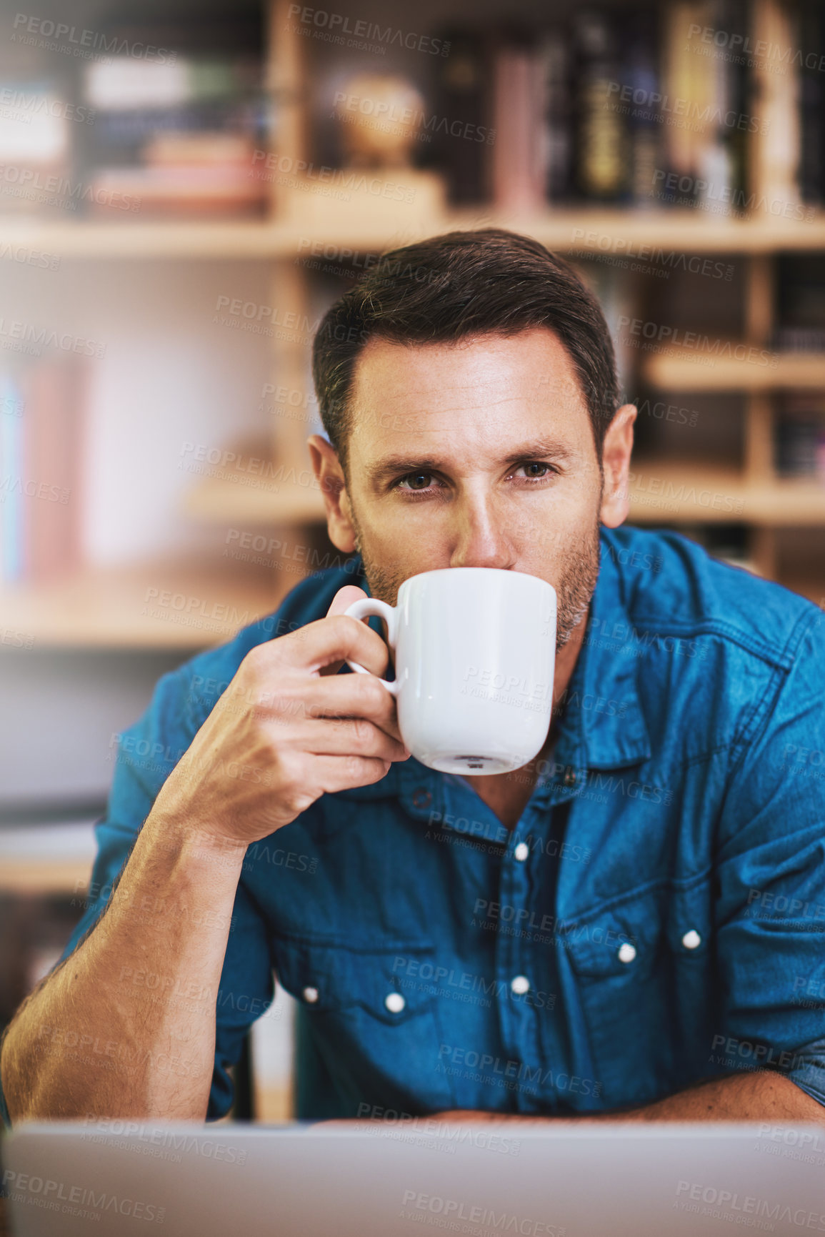 Buy stock photo Cropped shot of a businessman drinking coffee while working at home