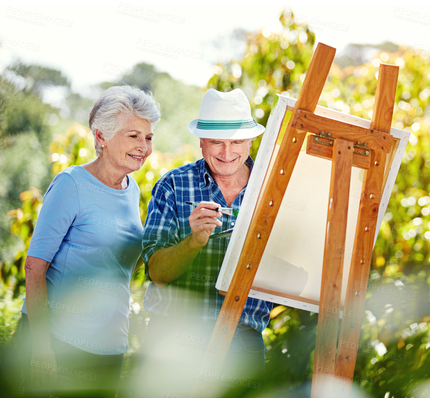 Buy stock photo Cropped shot of a senior couple painting in the park