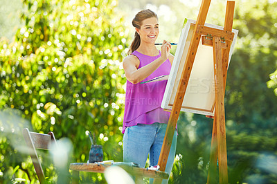 Buy stock photo Cropped shot of a young woman painting in the park