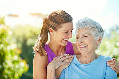 Buy stock photo Cropped shot of a young woman and her mother in the park
