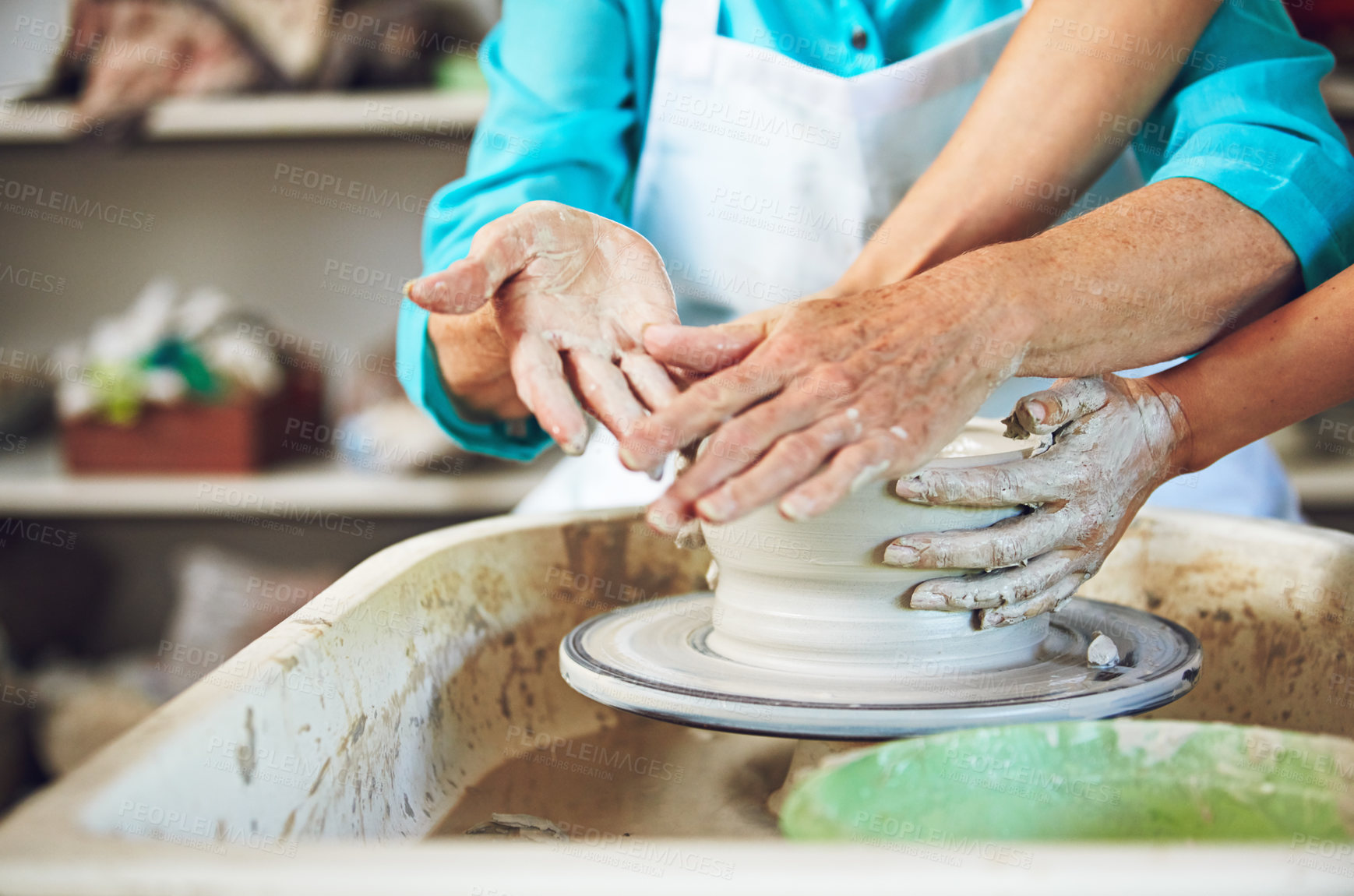 Buy stock photo Cropped shot of a senior couple making a ceramic pot together in a workshop