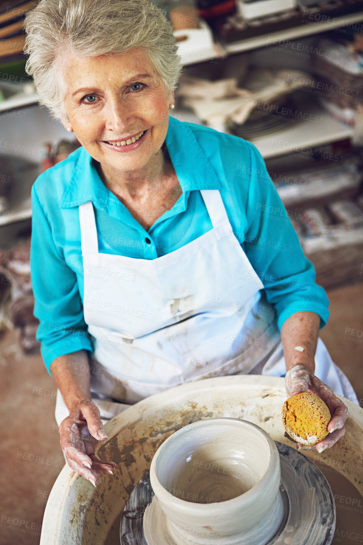 Buy stock photo Portrait of a senior woman making a ceramic pot in a workshop
