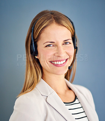 Buy stock photo Studio shot of a successful businesswoman against a blue background 