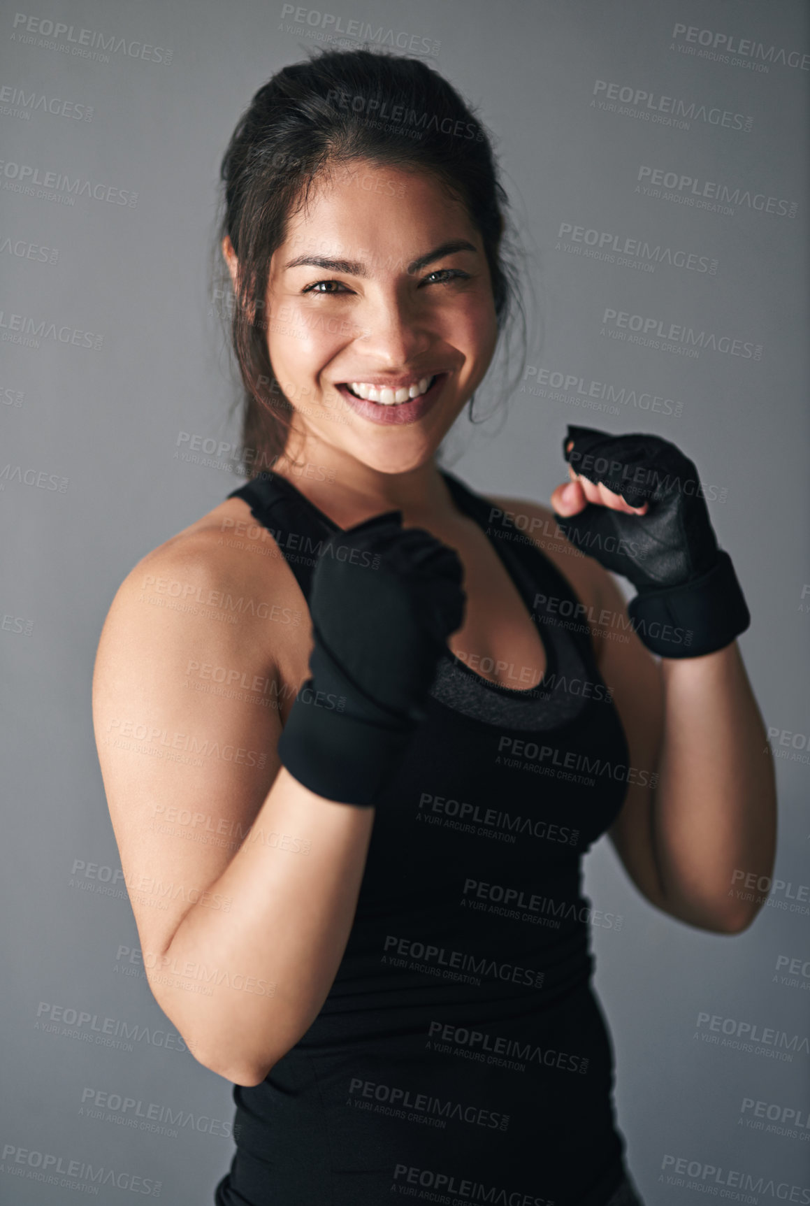 Buy stock photo Girl, portrait and fist in studio for training, cardio boxing and ready for fight tournament with power. Woman, happy and gray background for self defense with wellness, combat workout and endurance.